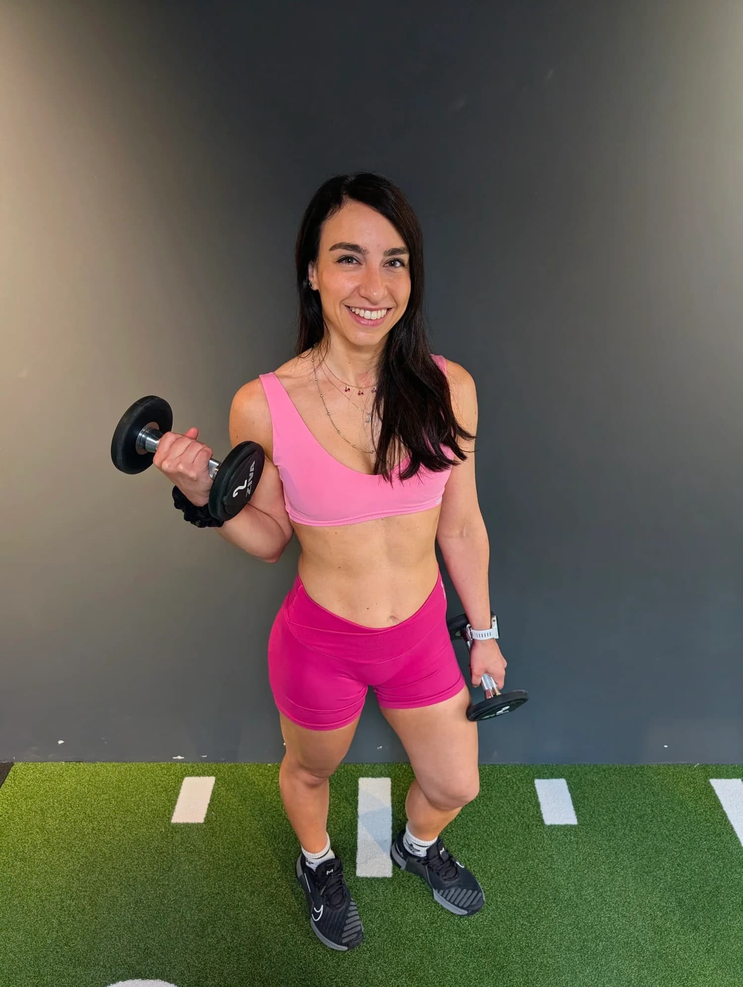 Roberta holding dumbbells