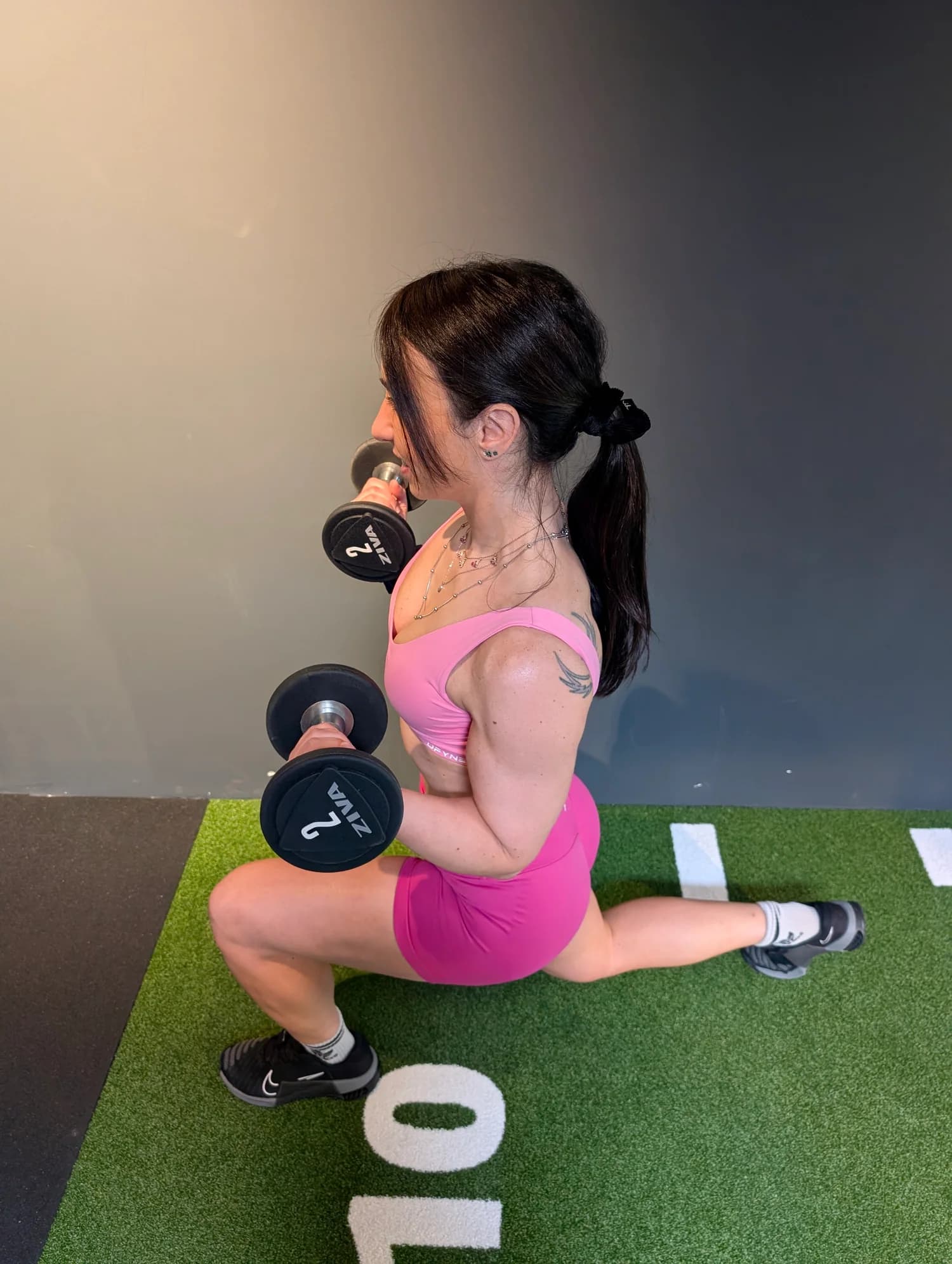 Roberta demonstrating a dumbbell lunge